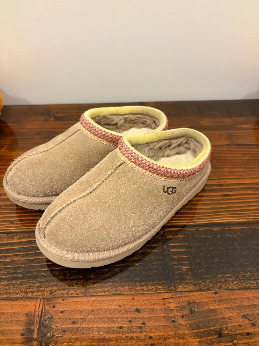 UGG Kids Slip-On Suede Slippers in Tan with Pink Trim
